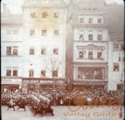 Historischer Militärumzug auf einer Stadtstraße mit Zuschauern im Jahre 1920
