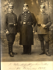 Drei Soldaten der Heertruppen in Uniform im Jahr 1915 vor einem bewaldeten Hintergrund