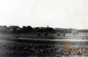 Historische Landschaft mit landwirtschaftlichen Feldern und alten Gebäuden in der Nähe eines kleinen Dorfes