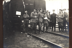 Soldaten der Heer, S.M.W. Zug 48 P.B. 11 stehen an einem Bahnhof und entspannen sich