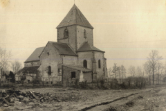 Kriegsbeschädigte Kirche mit romanischem Turm in französischem Dorf