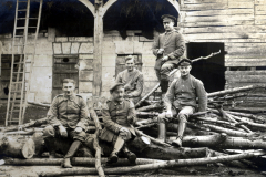 Deutsche Soldaten des Landwehr-Infanterie-Regiments 53 bei Holzarbeiten vor Bauernhaus