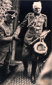 Ein militärischer Befehlshaber betritt eine elegante Residenz in historischer Uniform und mit zahlreichem Orden