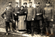 Soldaten und eine Zivilistin posieren stolz vor einem historischen Gebäude