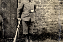 Ein junger Soldat während des Ersten Weltkriegs in uniformierter Kleidung und mit Gewehr in der Hand