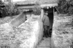 Soldat steht vor einem Eingangsbereich einer Bunkeranlage im Ersten Weltkrieg in Europa