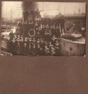 Gruppenfoto der Marinecrew vor einem Schiff im Hafen während des frühen 20. Jahrhunderts