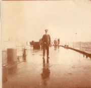 Mann auf dem Deck eines Schiffes während einer nassen und nebligen Tagesfahrt auf dem Meer