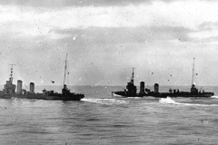 Zwei deutsche Torpedoboote fahren parallel in Formation auf ruhiger See. Die Schiffe zeigen die charakteristische Silhouette mit Schornsteinen und Aufbauten der kaiserlichen Kriegsmarine.