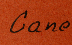 Handschriftliche Beschriftung "la Canoau" auf orangefarbenem Untergrund