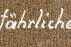 Handschriftliche Aufschrift auf Textil: 'Auf gefährlichem Wege'