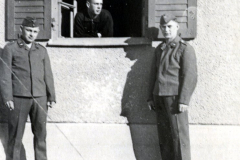Drei Soldaten vor Gebäudeeingang mit Fenster