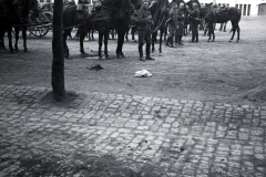 Uniformierte Reiter und Zuschauer auf gepflastertem Platz, 1933